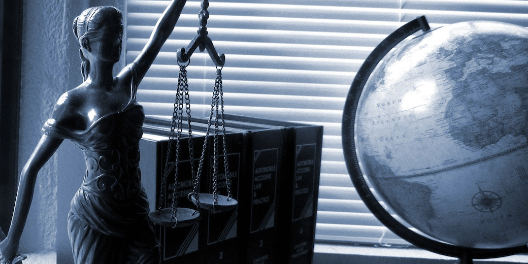 the scales of justice and a book