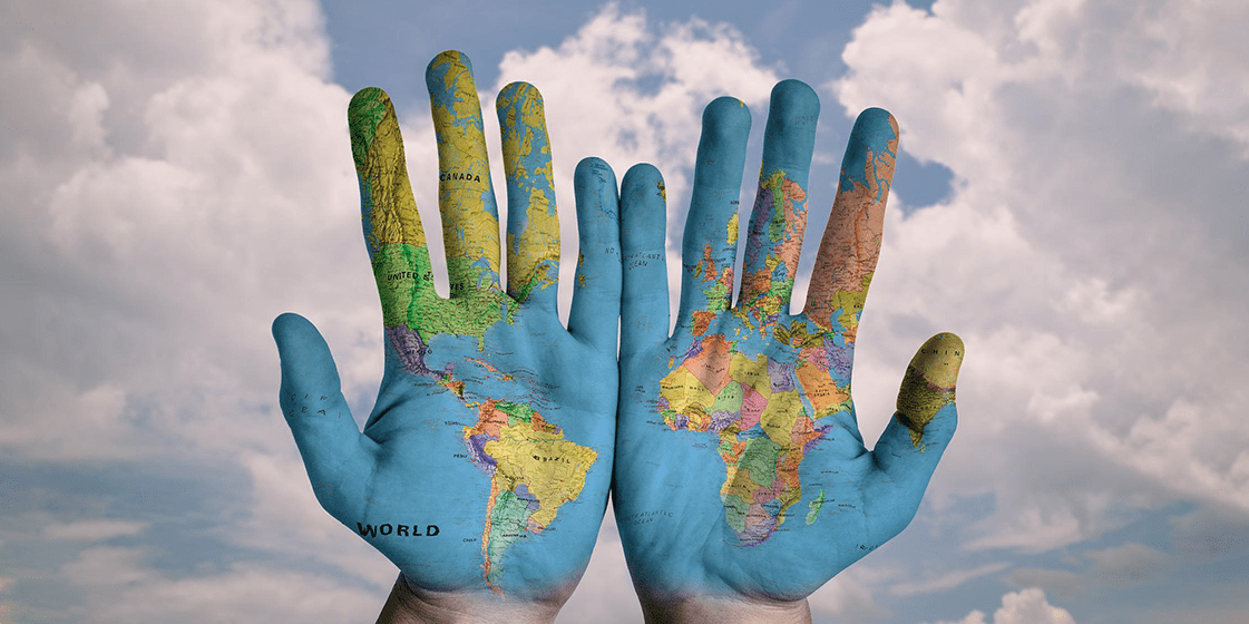 two hands, palms up, with the world atlas on them - the whole world in someone's hands